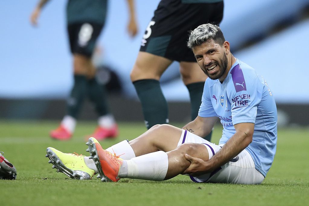 Manchester City's Sergio Aguero reacts as he sits on the pitch injured during the English Premier League soccer match between Manchester City and Burnley at Etihad Stadium, in Manchester, England, Monday, June 22, 2020. (AP Photo/Martin Rickett,Pool)