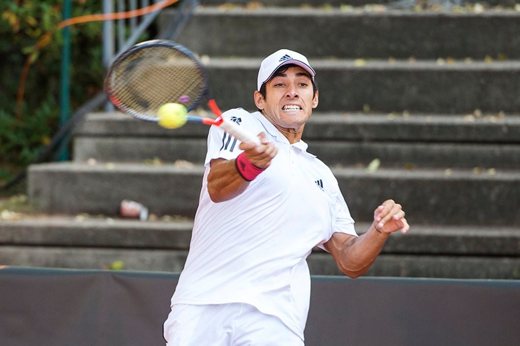 Christian Garin of Chile returns the ball during his 1st round tennis match against Kei Nishikori of Japan at the ATP Tour German Open in Hamburg, Germany, Tuesday, Sept. 22, 2020. (Daniel Bockwoldt/dpa via AP)