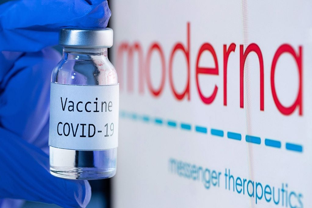(FILES) In this file photo  taken on November 18, 2020 shows a bottle reading "Vaccine Covid-19" next to the Moderna biotech company logo. - US firm Moderna said it would file requests for emergency authorization of its Covid-19 vaccine in the United States and Europe on November 30, 2020, after full results confirmed a high efficacy estimated at 94.1 percent. "We believe that our vaccine will provide a new and powerful tool that may change the course of this pandemic and help prevent severe disease, hospitalizations and death," said the company's CEO Stephane Bancel. (Photo by JOEL SAGET / AFP) / -- IMAGE RESTRICTED TO EDITORIAL USE - STRICTLY NO COMMERCIAL USE --