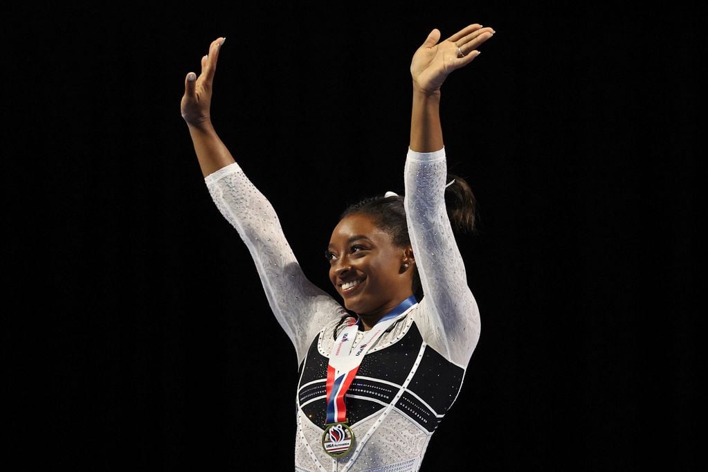 Aug 5, 2023; Hoffman Estates, Illinois, USA; Simone Biles (center) reacts during the awards ceremony after winning the all-around of the Core Hydration Classic at NOW Arena. Mandatory Credit: Jon Durr-USA TODAY Sports