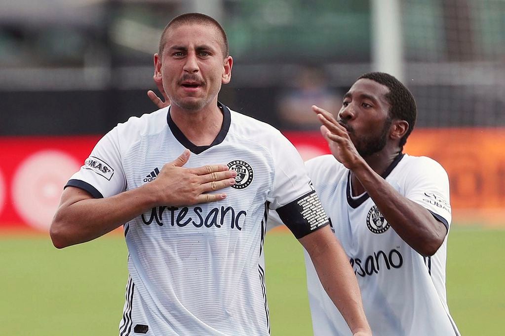 Philadelphia Union soccer player player Sergio Santos, left, celebrates with teammate Raymon Gaddis after scoring a goal against New York City FC during the MLS is Back tournament at Disney's ESPN Wide World of Sports in Orlando, Fla., Thursday, July 9, 2020. (Stephen M. Dowell/Orlando Sentinel via AP)