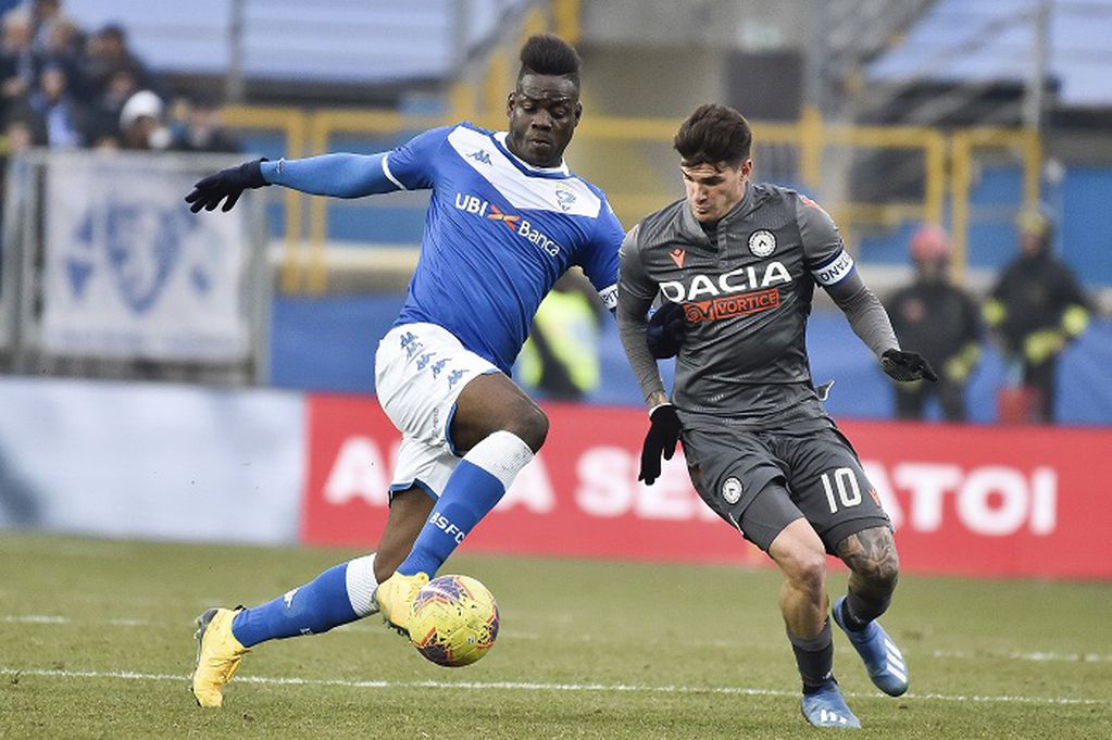 FILE - In this Sunday, Feb. 9, 2020 filer, Udinese's Rodrigo De Paul, right, and Brescia's Mario Balotelli vie for the ball, during a Italian Serie A soccer match at the Mario Rigamonti stadium in Brescia, Italy. Former Italy striker Mario Balotelli was reportedly fired by his hometown club for failing to report for training as the Italian soccer season prepares to resume from a three-month break due to the coronavirus pandemic. (Gianluca Checchi/LaPresse via AP, File )