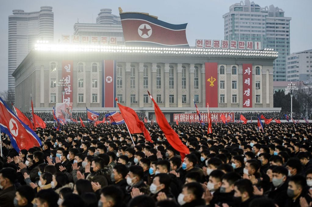 In this picture taken on January 5, 2022, people take part in a rally to carry out the decision of the 4th Plenary Meeting of the 8th Central Committee of the Workers' Party of Korea, at Kim Il Sung Square in Pyongyang. (Photo by KIM Won Jin / AFP)