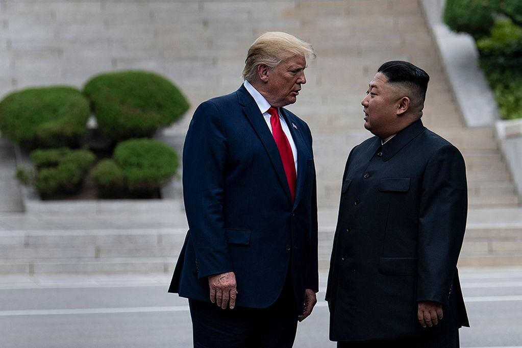 (FILES) In this file photo taken on June 30, 2019, US President Donald Trump and North Korea's leader Kim Jong-un stand on North Korean soil while walking to South Korea in the Demilitarized Zone(DMZ), in Panmunjom, Korea. - US President Donald Trump on April 23, 2020 rejected reports that North Korean leader Kim Jong Un was ailing, criticizing his frequent nemesis CNN for running the story. (Photo by Brendan Smialowski / AFP)