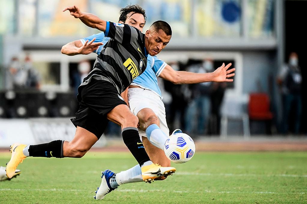 Lazio's Italian midfielder Marco Parolo (Rear) tackles Inter Milan's Chilean forward Alexis Sanchez during the Italian Serie A football match Lazio vs Inter on October 4, 2020 at the Olympic stadium in Rome. (Photo by Filippo MONTEFORTE / AFP)