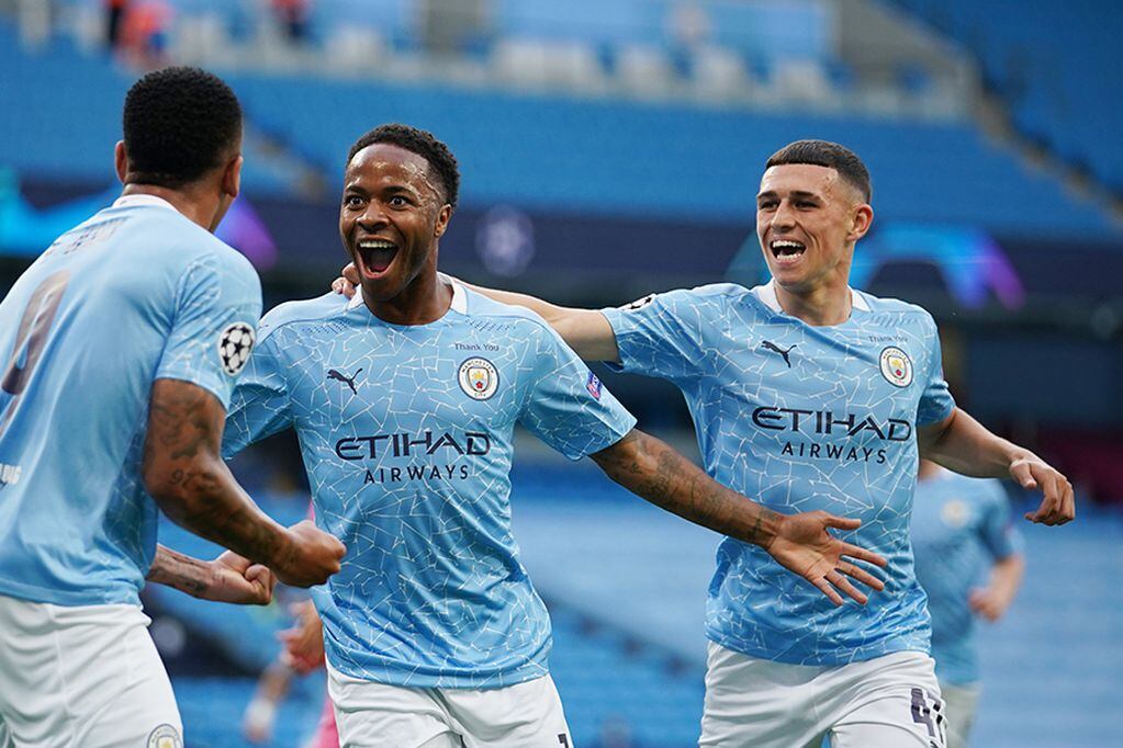 Soccer Football - Champions League - Round of 16 Second Leg - Manchester City v Real Madrid - Etihad Stadium, Manchester, Britain - August 7, 2020 Manchester City's Raheem Sterling celebrates scoring their first goal with teammates, as play resumes behind closed doors following the outbreak of the coronavirus disease (COVID-19) Pool via REUTERS/Dave Thompson