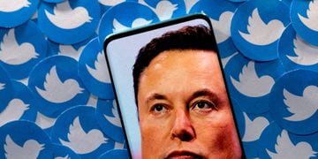 FILE PHOTO: Illustration shows Elon Musk image on smartphone and printed Twitter logos
