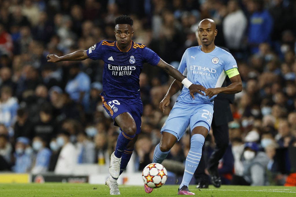 Soccer Football - Champions League - Semi Final - First Leg - Manchester City v Real Madrid - Etihad Stadium, Manchester, Britain - April 26, 2022 Real Madrid's Vinicius Junior in action with Manchester City's Fernandinho Action Images via Reuters/Jason Cairnduff