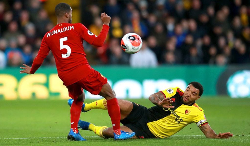 29 February 2020, England, Watford: Liverpool's Georginio Wijnaldum (L) and Watford's Troy Deeney battle for the ball during the English Premier League soccer match between Watford FC and Liverpool FC at Vicarage Road. Photo: Adam Davy/PA Wire/dpa