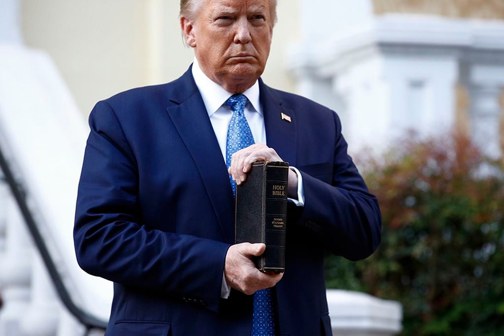 President Donald Trump holds a Bible as he stands outside St. John's Church across Lafayette Park from the White House in Washington on June 1, 2020, after law enforcement officers used tear gas and other riot control tactics to forcefully clear peacef...