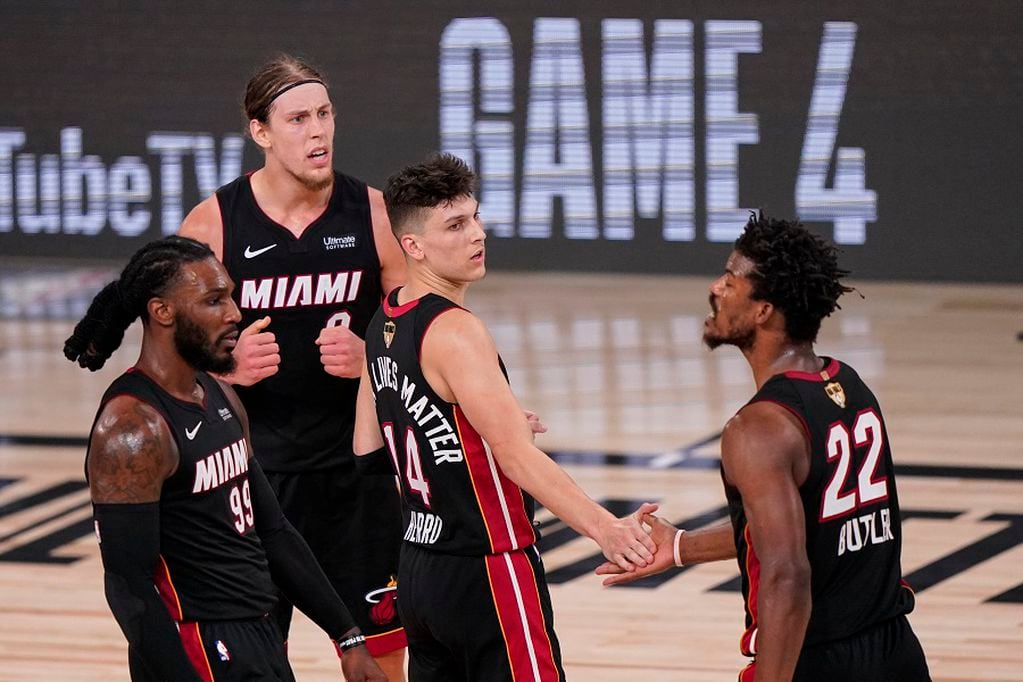 Miami Heat's Tyler Herro, center, high fives Jimmy Butler (22) along with Kelly Olynyk, top left, and Jae Crowder, left, after a win against Los Angeles Lakers 115-104 after Game 3 of basketball's NBA Finals, Sunday, Oct. 4, 2020, in Lake Buena Vista, Fla. (AP Photo/Mark J. Terrill)