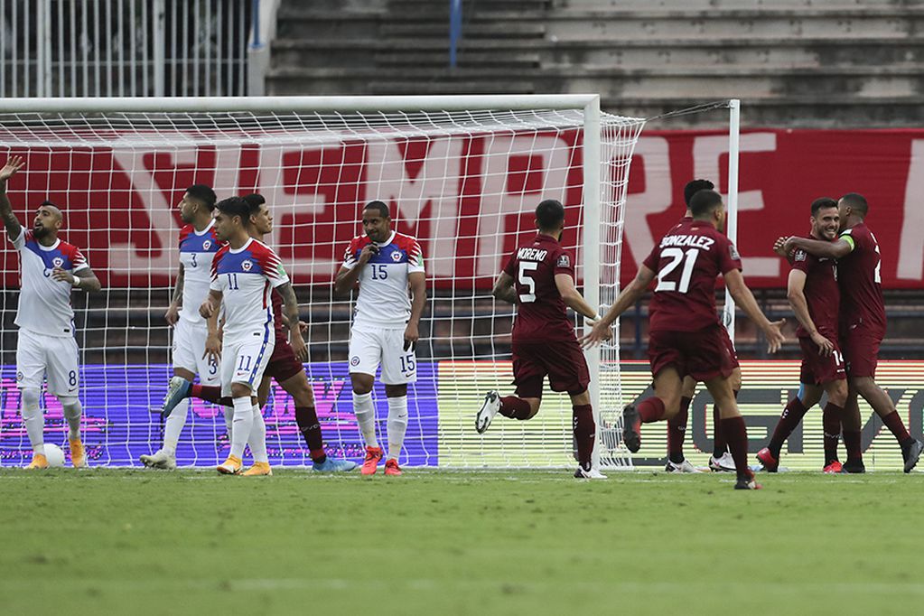 Venezuela's Luis del Pino, second right, celebrates scoring his side's opening goal against Chile with teammates during a qualifying soccer match for the FIFA World Cup Qatar 2022 in Caracas, Venezuela, Tuesday, Nov. 17, 2020. (Miguel Gutierrez, Pool via AP)