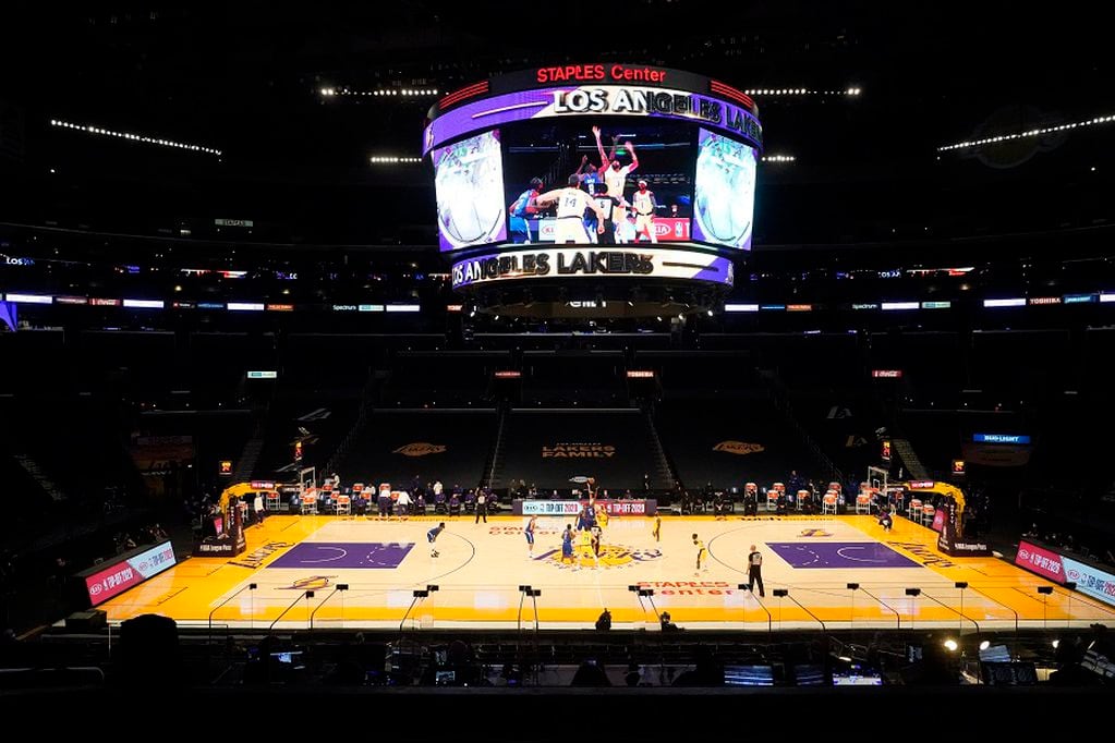 The Los Angeles Lakers and the Los Angeles Clippers tip off in an empty Staples Center amid the coronavirus pandemic, to start an NBA basketball game Tuesday, Dec. 22, 2020, in Los Angeles. (AP Photo/Marcio Jose Sanchez)