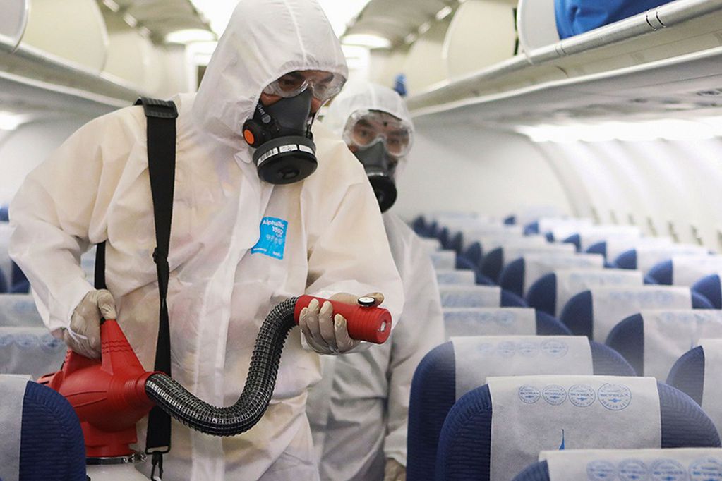 This handout photo released March 3, 2020 by Bangkok Airways shows workers wearing protective suit disinfecting a Bangkok Airways aircraft in Bangkok amid fears of the spread of the COVID-19 novel coronavirus. (Photo by Handout / BANGKOK AIRWAYS / AFP) / -----EDITORS NOTE --- RESTRICTED TO EDITORIAL USE - MANDATORY CREDIT "AFP PHOTO / BANGKOK AIRWAYS" - NO MARKETING - NO ADVERTISING CAMPAIGNS - DISTRIBUTED AS A SERVICE TO CLIENTS - NO ARCHIVE