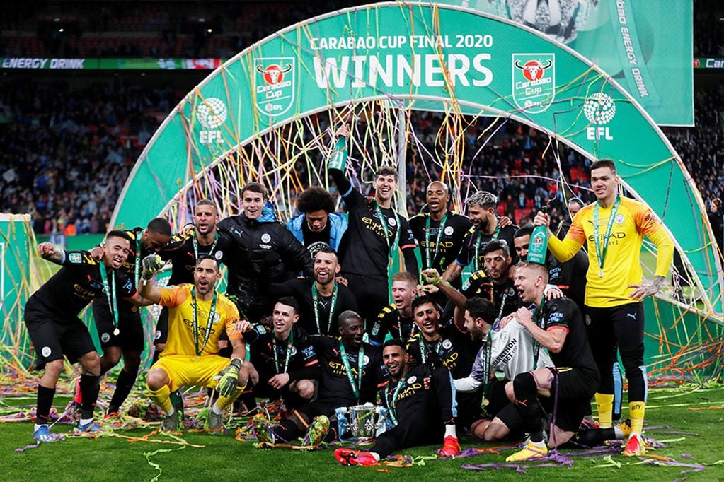 Soccer Football - Carabao Cup Final - Aston Villa v Manchester City - Wembley Stadium, London, Britain - March 1, 2020  Manchester City players pose with the trophy as they celebrate winning the Carabao Cup   Action Images via Reuters/Matthew Childs  EDITORIAL USE ONLY. No use with unauthorized audio, video, data, fixture lists, club/league logos or "live" services. Online in-match use limited to 75 images, no video emulation. No use in betting, games or single club/league/player publications.  Please contact your account representative for further details.