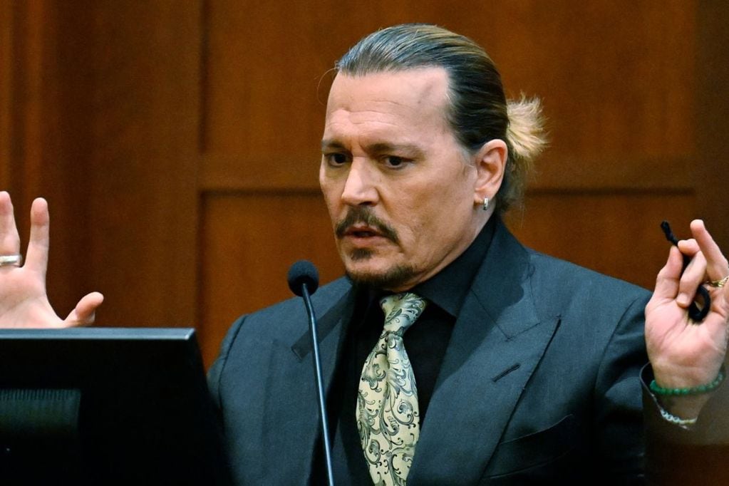 US actor Johnny Depp testifies during his defamation trial in the Fairfax County Circuit Courthouse in Fairfax, Virginia, on April 19, 2022. - Depp is suing ex-wife Amber Heard for libel after she wrote an op-ed piece in The Washington Post in 2018 referring to herself as a ìpublic figure representing domestic abuse.î (Photo by JIM WATSON / POOL / AFP)