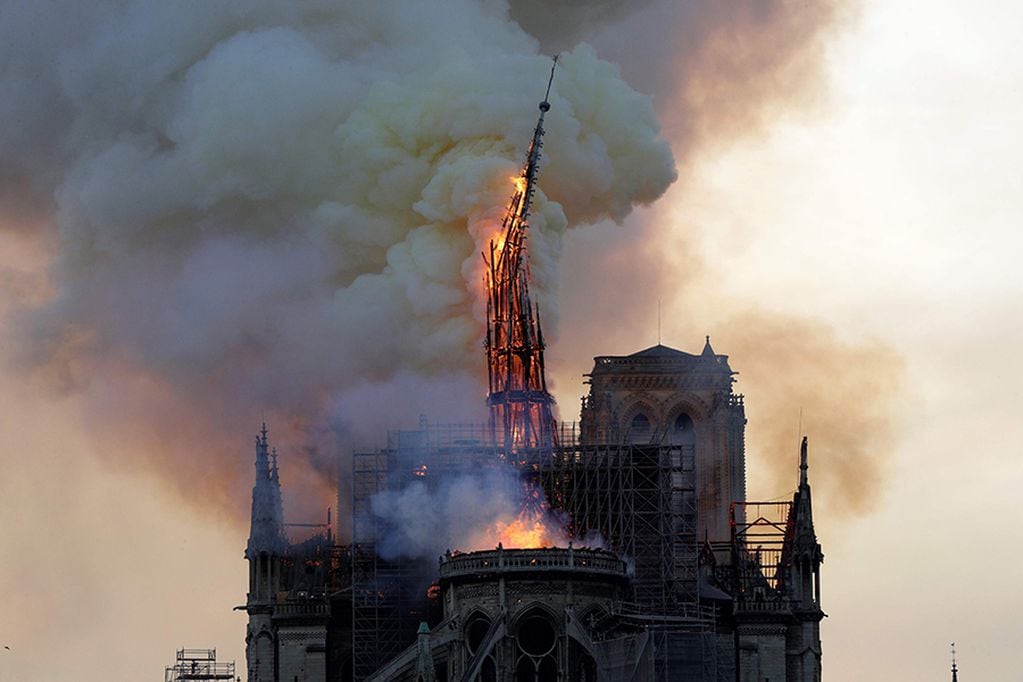 The steeple of the landmark Notre-Dame Cathedral collapses as the cathedral is engulfed in flames in central Paris on April 15, 2019.


 A huge fire swept through the roof of the famed Notre-Dame Cathedral in central Paris on April 15, 2019, sending fl...