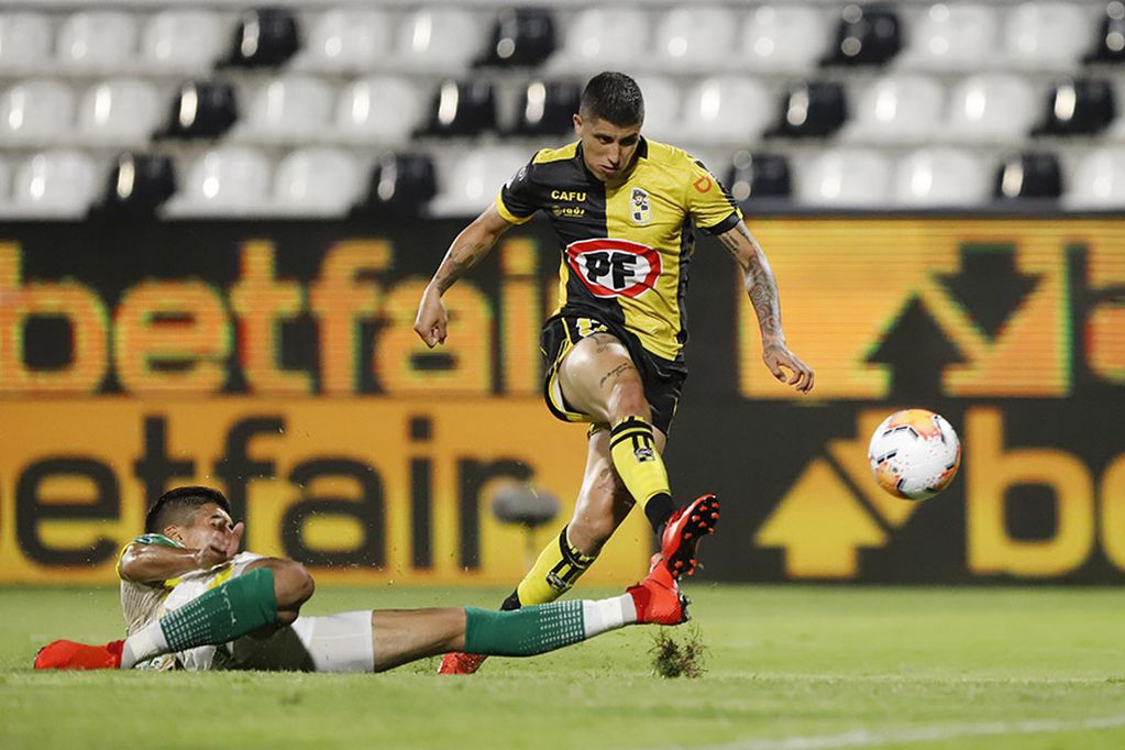 Ruben Farfan of Chile's Coquimbo, right, and Adonis Frias of Argentina's Defensa y Justicia battle for the ball during a Copa Sudamericana semifinal soccer match in Asuncion, Paraguay, Tuesday, Jan. 12, 2021. (Nathalia Aguilar, Pool via AP)
