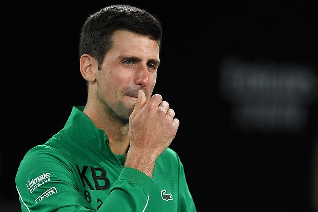 Serbia's Novak Djokovic gets emotional as he talks about Kobe Bryant after winning the men's singles quarter-final match against Canada's Milos Raonic on day nine of the Australian Open tennis tournament in Melbourne on January 28, 2020. (Photo by Greg Wood / AFP) / IMAGE RESTRICTED TO EDITORIAL USE - STRICTLY NO COMMERCIAL USE