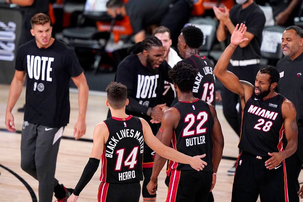 Miami Heat's Tyler Herro (14) and Miami Heat's Andre Iguodala (28) celebrate during the second half of an NBA conference final playoff basketball game against the Boston Celtics Sunday, Sept. 27, 2020, in Lake Buena Vista, Fla. (AP Photo/Mark J. Terrill)