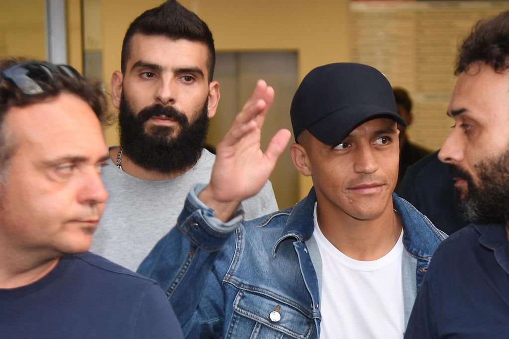 Alexis Sanchez, second from right, waves to fans upon his arrival at the Coni (Italian Olympic Committee) office for medical checks, in Milan, Italy, Wednesday, Aug. 28, 2019. Sanchez will leave Manchester united on a loan deal with the Italian Serie A...