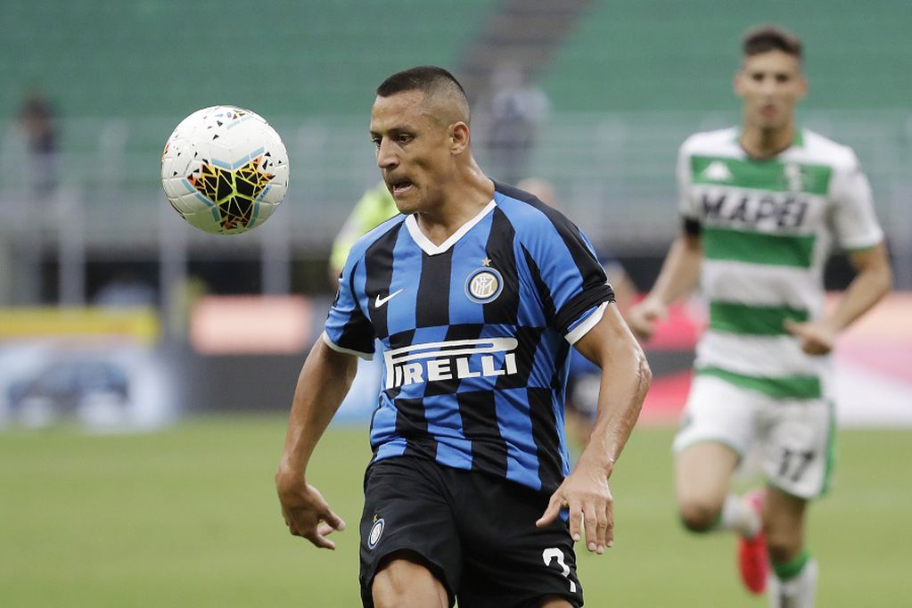Inter Milan's Alexis Sanchez controls the ball during the Serie A soccer match between Inter Milan and Sassuolo at the San Siro Stadium, in Milan, Italy, Wednesday, June 24, 2020. (AP Photo/Luca Bruno)