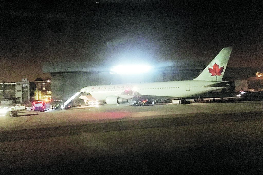 An Air Canada Boeing 767 aircraft is parked at Barajas international airport after making a safe emergency landing in Madrid, Spain, Monday Feb. 3, 2020. Toronto-bound flight AC837 had left from the Spanish capital in the early afternoon on Monday but had to request an emergency return after one of its two engines was damaged and a tire ruptured during takeoff. (AP Photo/G.W. Ortega)