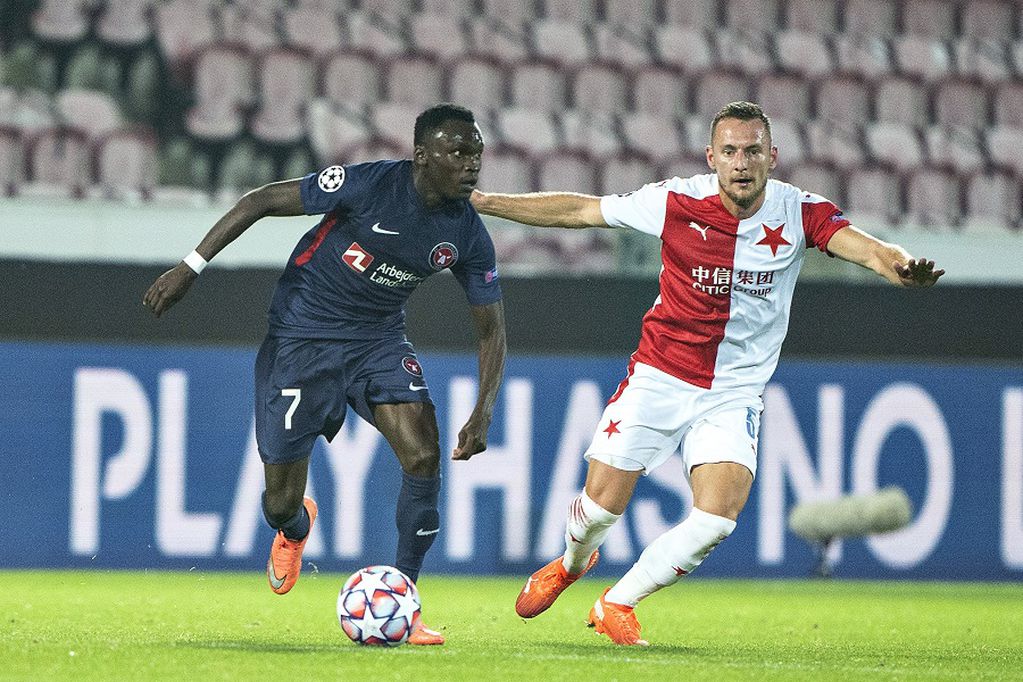 FC Midtjylland's Pione Sisto, left, vies for the ball with Slavia Prague's David Zima, during the Champions League play off qualifier soccer match between FC Midtjylland and Slavia Prague at MCH Arena in Herning, Denmark, Wednesday, Sept. 30 2020. (Henning Bagger/Ritzau Scanpix via AP)