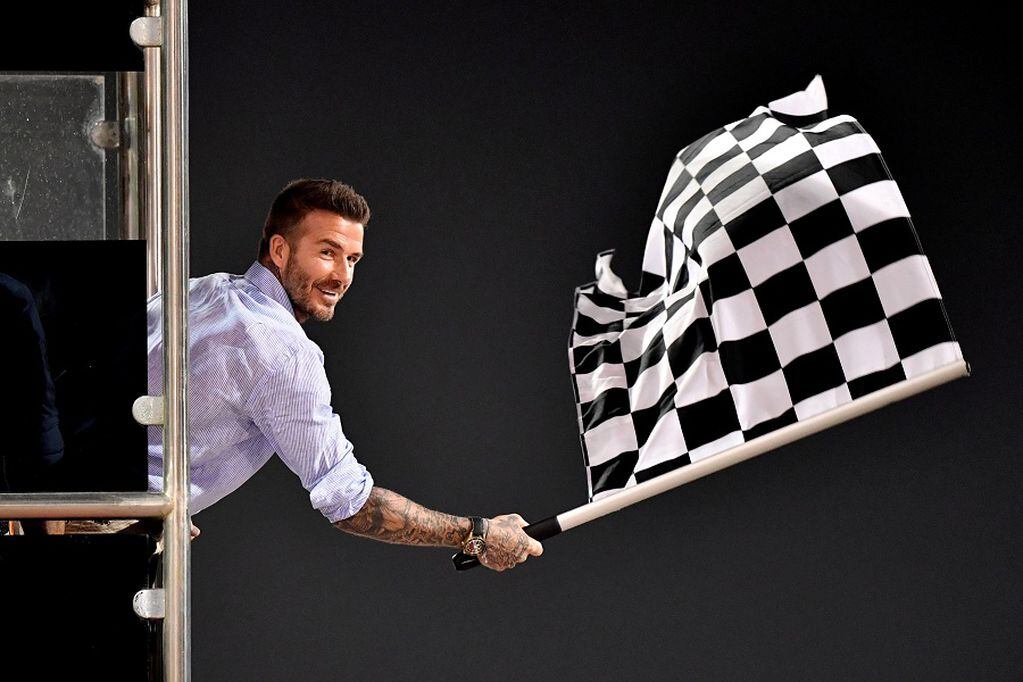 FILE PHOTO: Formula One F1 - Bahrain Grand Prix - Bahrain International Circuit, Sakhir, Bahrain - March 31, 2019  David Beckham waves the chequered flag at the end of the race Andrej Isakovic/Pool via REUTERS/File Photo
