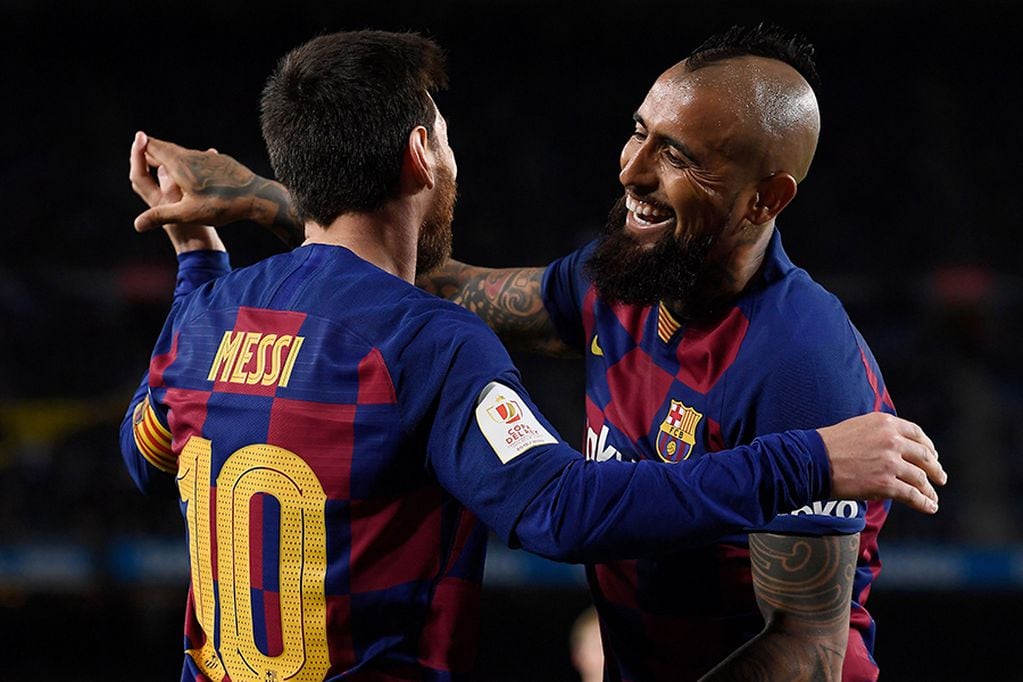 Barcelona's Argentine forward Lionel Messi celebrates with Barcelona's Chilean midfielder Arturo Vidal after scoring his team's third goal during the Copa del Rey (King's Cup) football match between FC Barcelona and Club Deportivo Leganes SAD at the Camp Nou stadium in Barcelona, on January 30, 2020. (Photo by Josep LAGO / AFP)