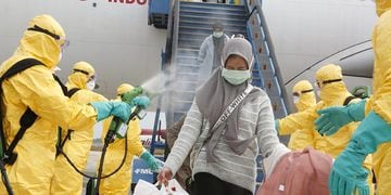 Medical officers prepare evacuated Indonesian nationals from Wuhan, China's center of the coronavirus epidemic, before transferring them to the Natuna Islands military base to be quarantined, at Hang Nadim Airport in Batam, Riau Islands