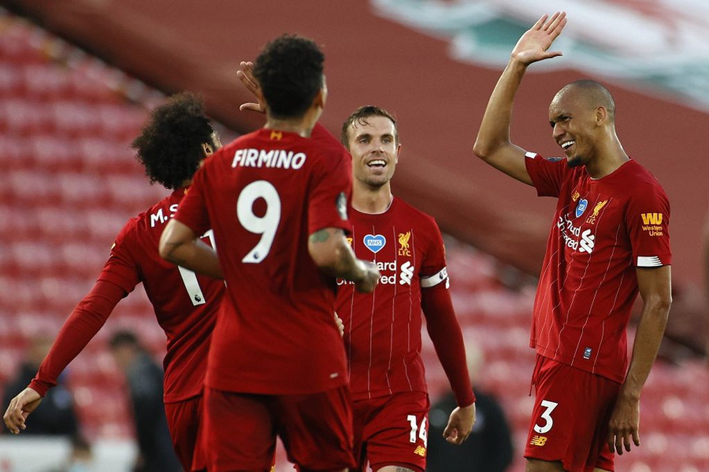Liverpool's Fabinho, right, celebrates scoring his side's third goal during the English Premier League soccer match between Liverpool and Crystal Palace at Anfield Stadium in Liverpool, England, Wednesday, June 24, 2020. (Phil Noble/Pool via AP)