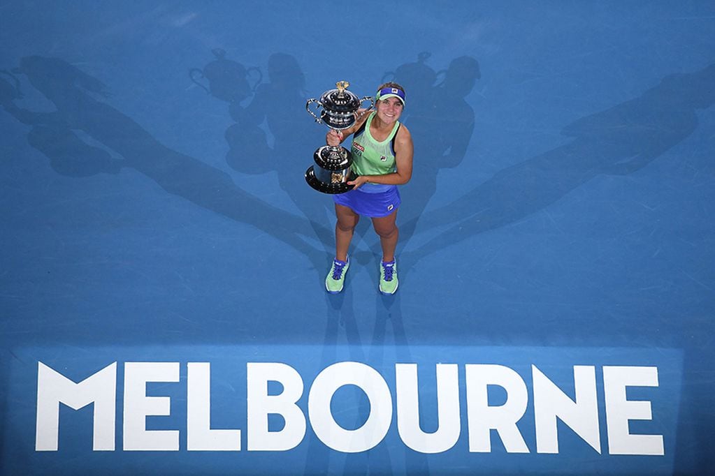 Sofia Kenin of the US holds the Daphne Akhurst Memorial Cup after beating Spain's Garbine Muguruza in their women's singles final match on day thirteen of the Australian Open tennis tournament in Melbourne on February 1, 2020. (Photo by William WEST / AFP) / IMAGE RESTRICTED TO EDITORIAL USE - STRICTLY NO COMMERCIAL USE