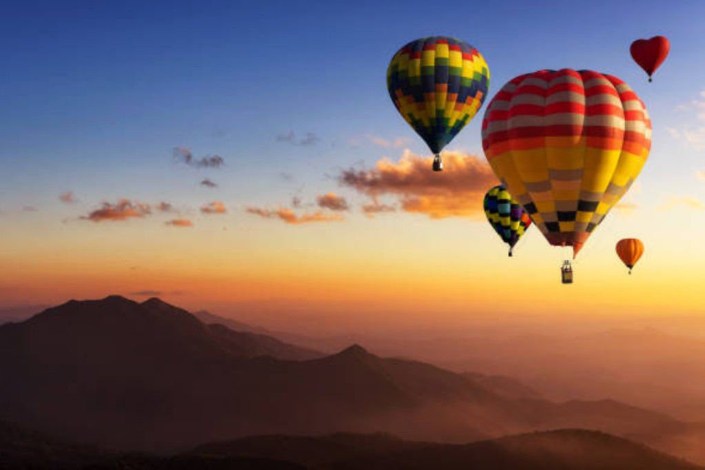 Beautiful colorful hot air balloons flying over mountain at view point Sunset of travel place, Doi inthanon, Chiang mai's Hidden Paradise in Thailand.