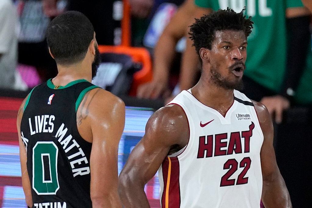 Boston Celtics' Jayson Tatum (0) walks away as Miami Heat's Jimmy Butler (22) celebrates his game-tying basket late in the second half of an NBA conference final playoff basketball game, Tuesday, Sept. 15, 2020, in Lake Buena Vista, Fla. (AP Photo/Mark J. Terrill)