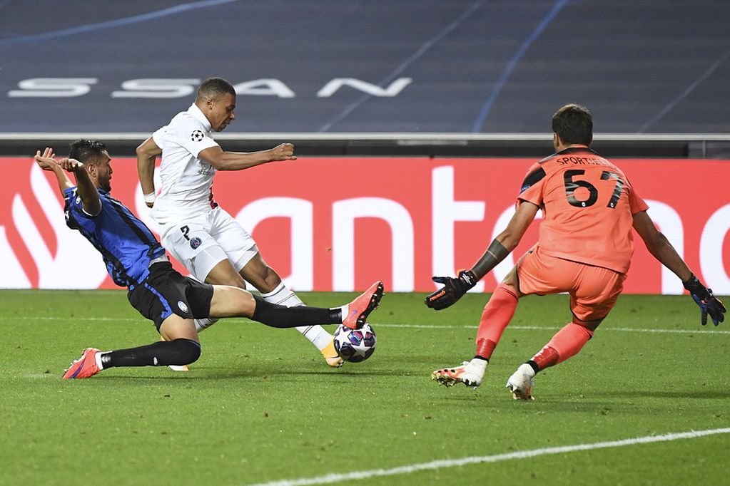PSG's Kylian Mbappe, centre, attempts a shot on goal during the Champions League quarterfinal match between Atalanta and PSG at Luz stadium, Lisbon, Portugal, Wednesday, Aug. 12, 2020. (David Ramos/Pool Photo via AP)
