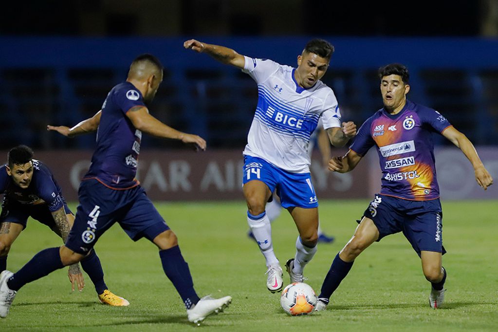 Chile's Universidad Catolica Cesar Pinares (C) is challenged by Paraguay's Sol de America Diego Valdez (R) and Miguel Samudio during their closed-door Copa Sudamericana second round football match at the Luis Alfonso Giagni Stadium in Asuncion, on October 29, 2020, amid the COVID-19 novel coronavirus pandemic. (Photo by Nathalia AGUILAR / POOL / AFP)