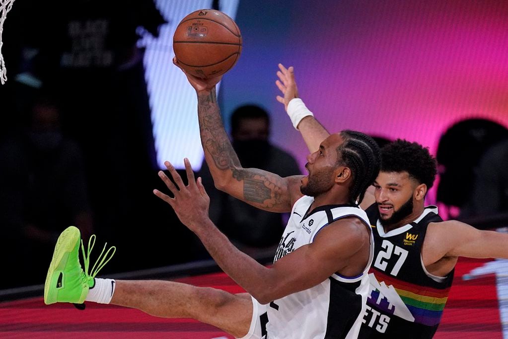 Los Angeles Clippers' Kawhi Leonard (2) shoots against Denver Nuggets' Jamal Murray (27) during the second half of an NBA conference semifinal playoff basketball game, Wednesday, Sept. 9, 2020, in Lake Buena Vista, Fla. (AP Photo/Mark J. Terrill)