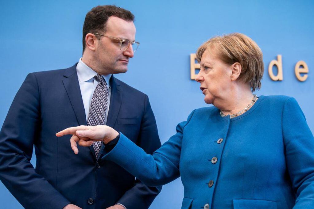 Spahn y Merkel