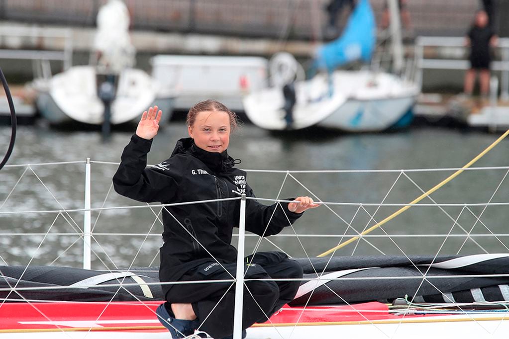 Greta Thunberg, a 16-year-old Swedish climate activist, waves after sailing in New York harbor aboard the Malizia II, Wednesday, Aug. 28, 2019. The zero-emissions yacht left Plymouth, England on Aug. 14. She is scheduled to address the United Nations Climate Action Summit on Sept. 23. (AP Photo/Mary Altaffer)