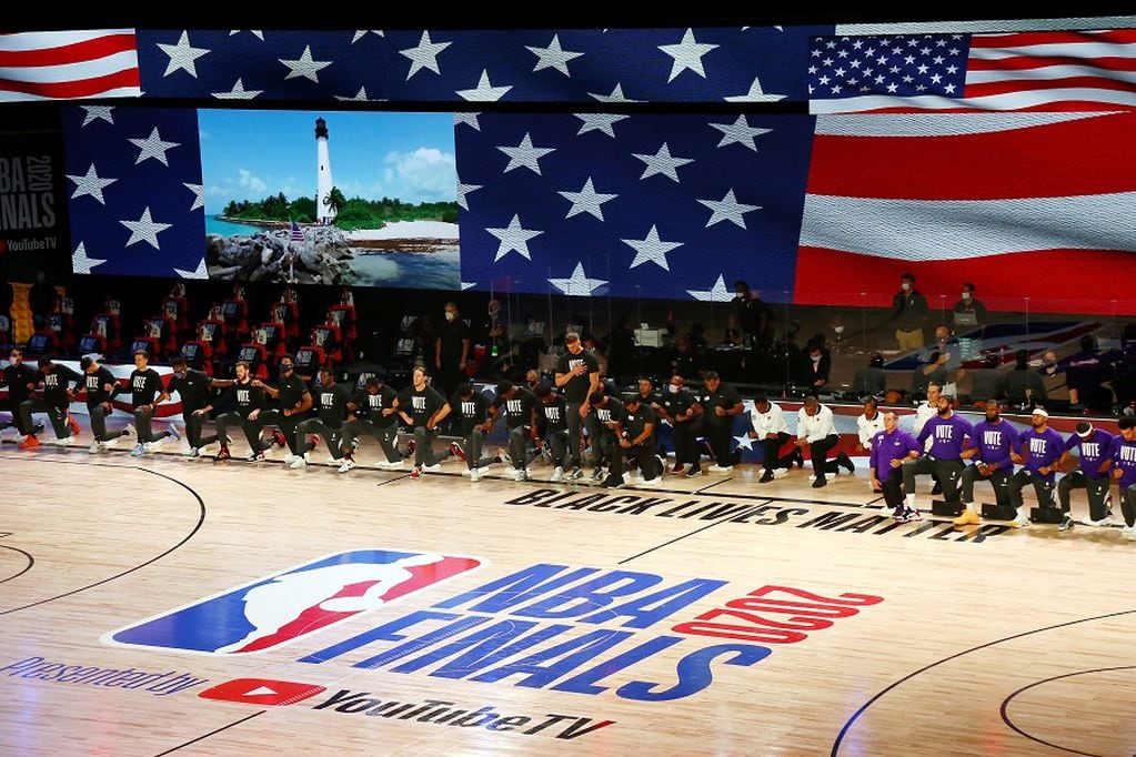 Oct 11, 2020; Lake Buena Vista, Florida, USA; The Miami Heat and Los Angeles Lakers during the national anthem before game six of the 2020 NBA Finals at AdventHealth Arena. Mandatory Credit: Kim Klement-USA TODAY Sports