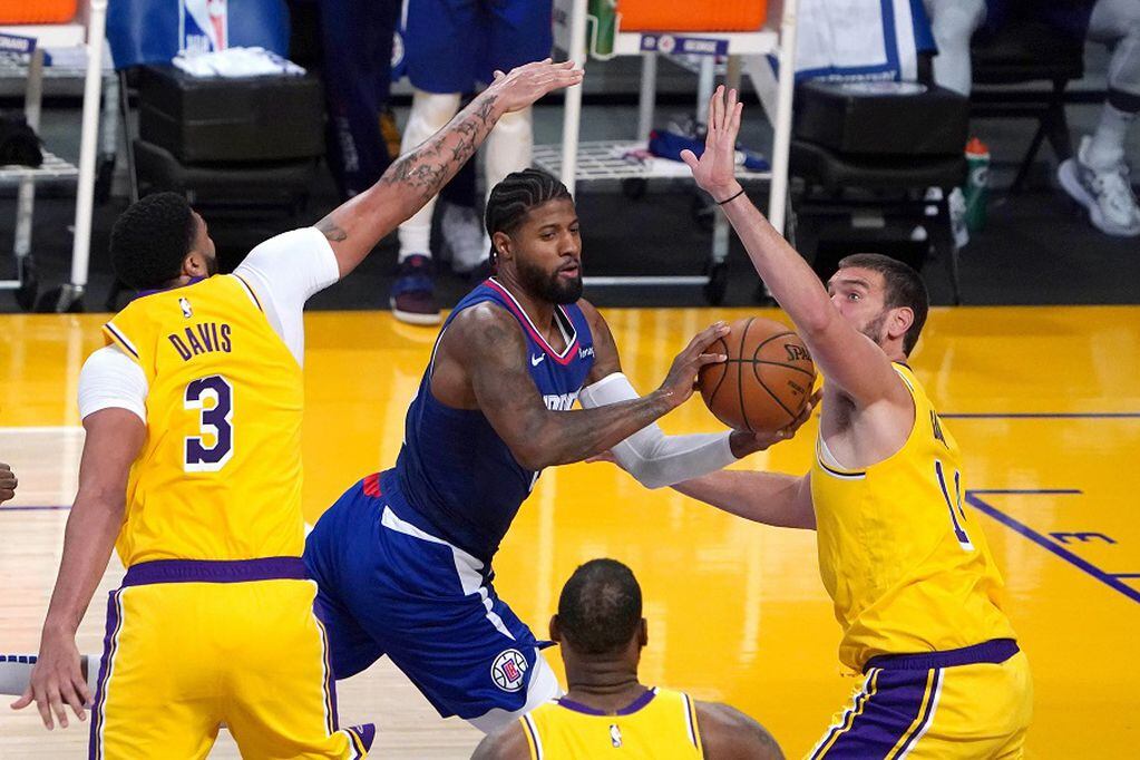 Dec 22, 2020; Los Angeles, California, USA; LA Clippers guard Paul George (13) drives against Los Angeles Lakers forward Anthony Davis (3) and center Marc Gasol (14) in the second quarter at Staples Center. Mandatory Credit: Kirby Lee-USA TODAY Sports