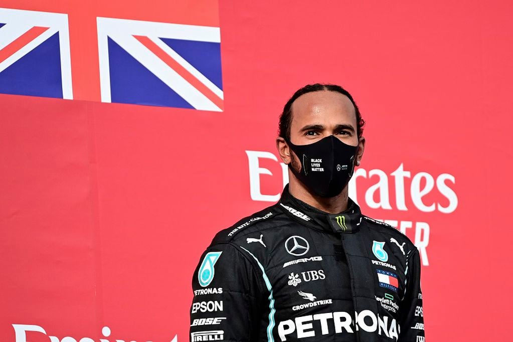 Mercedes driver Lewis Hamilton of Britain stands on the podium after winning the Emilia Romagna Formula One Grand Prix, at the Enzo and Dino Ferrari racetrack, in Imola, Italy, Sunday, Nov.1, 2020. (Miguel Medina, Pool via AP)