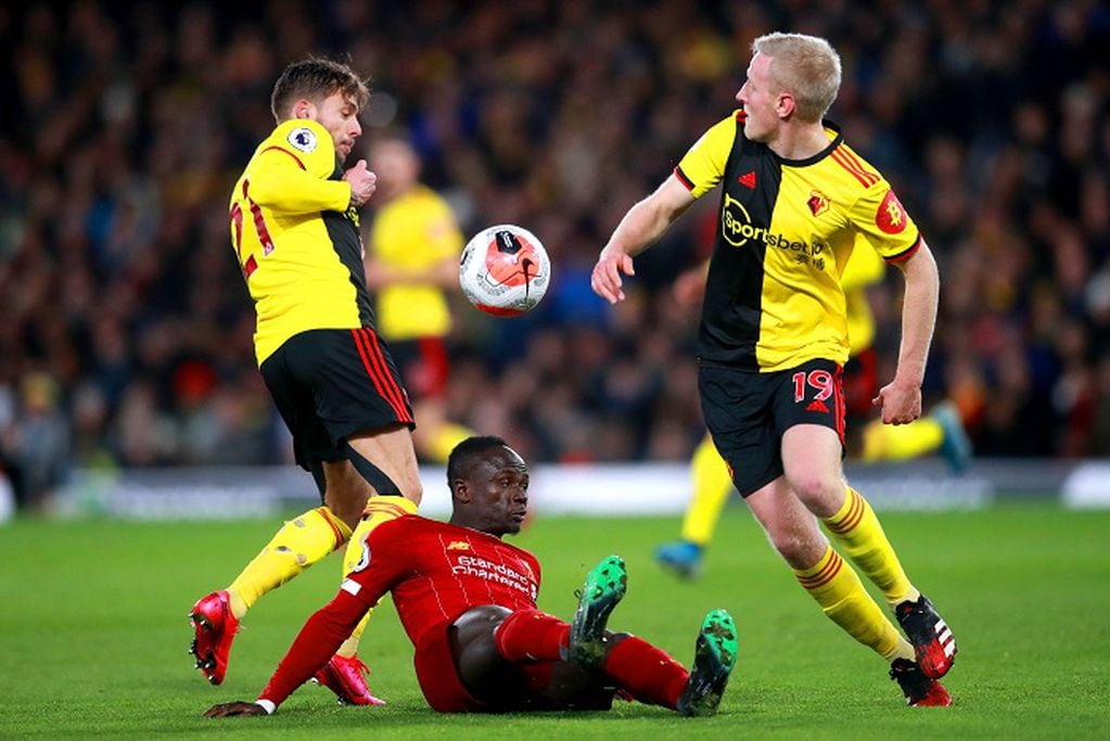 29 February 2020, England, Watford: Liverpool's Sadio Mane (C) battles for the ball with Watford's Kiko Femenia (L) and Will Hughes during the English Premier League soccer match between Watford FC and Liverpool FC at Vicarage Road. Photo: Adam Davy/PA Wire/dpa