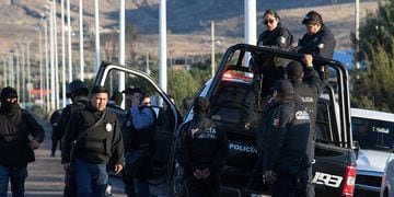 Police officers stand atop a vehicle as they keep watch outside the prison after sixteen inmates were killed and five were wounded in a prison fight at the Regional Center for Social Reintegration in the town of Cieneguillas
