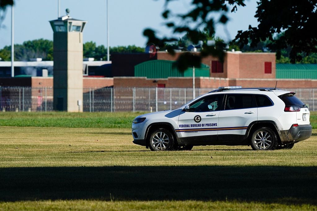 A correction officer patrols outside Federal Correctional Institution, Terre Haute, as Daniel Lewis Lee, convicted in the killing of three members of an Arkansas family in 1996, is set to be put to death in the first federal execution in 17 years, in Terre Haute, Indiana, U.S. July 13, 2020.  REUTERS/Bryan Woolston
