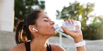 Portrait of a young fitness girl in earphones