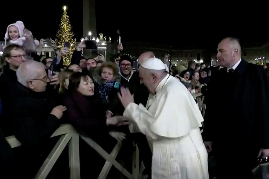 Pope Francis slaps the hand of a woman who grabbed him, at Saint Peter's Square at the Vatican