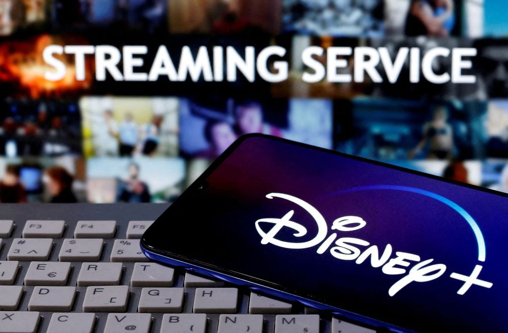 FILE PHOTO: A smartphone with displayed "Disney" logo is seen on the keyboard in front of displayed "Streaming service" words in this illustration taken March 24, 2020. REUTERS/Dado Ruvic/File Photo