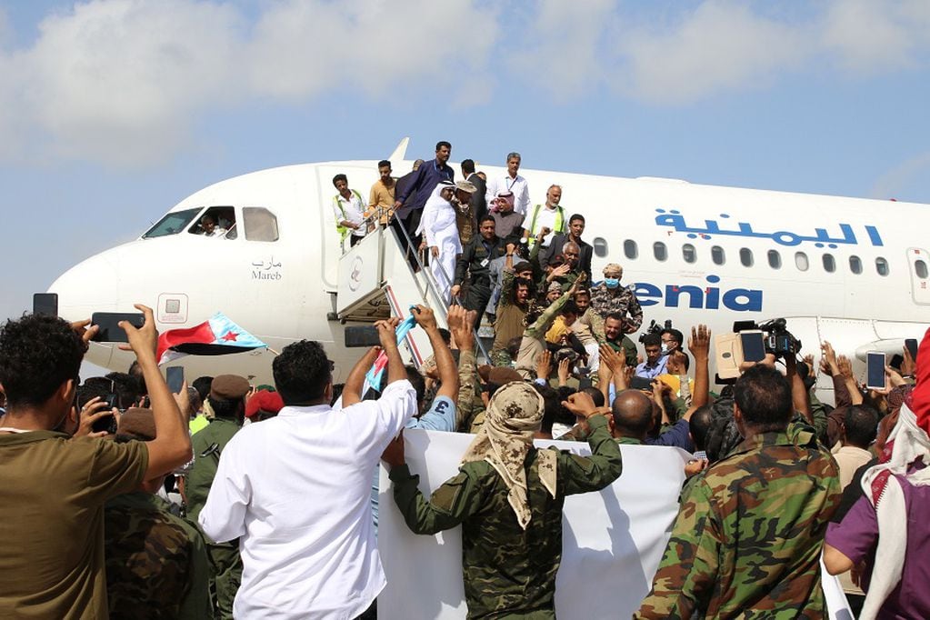 People wait to greet members a newly formed cabinet for government-held parts of Yemen upon their arrival at Aden airport, before an attack on the airport, in Aden, Yemen December 30, 2020. REUTERS/Fawaz Salman